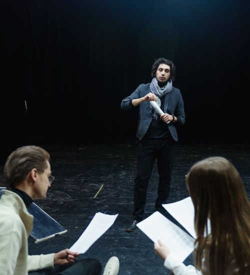 Woman performing a light cardio exercise in a stylish dark room with magenta ambient light.